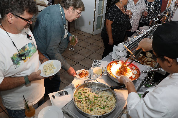 a buffet line with people waiting