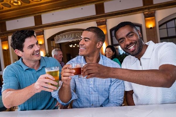 three men enjoying themselves at a bar