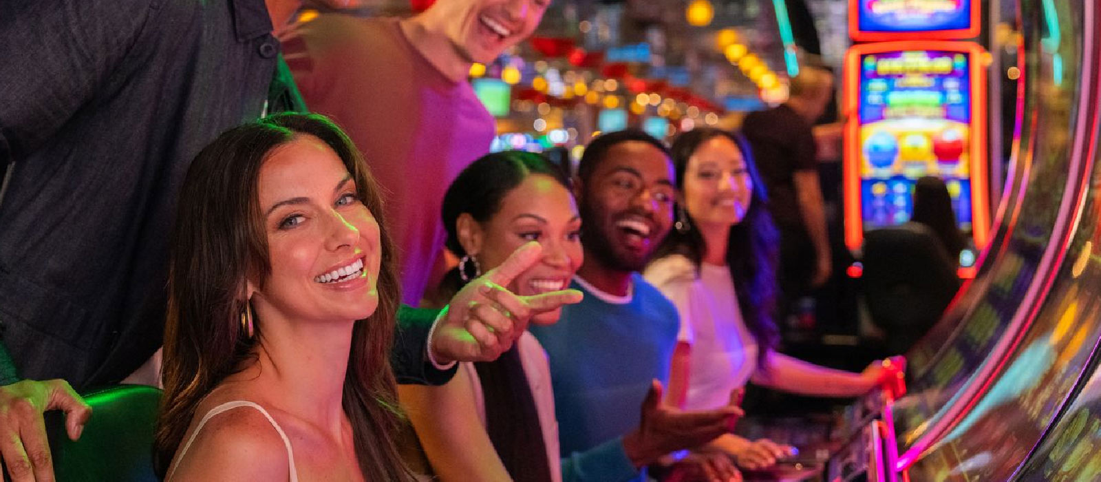 people smiling sitting at slot machines
