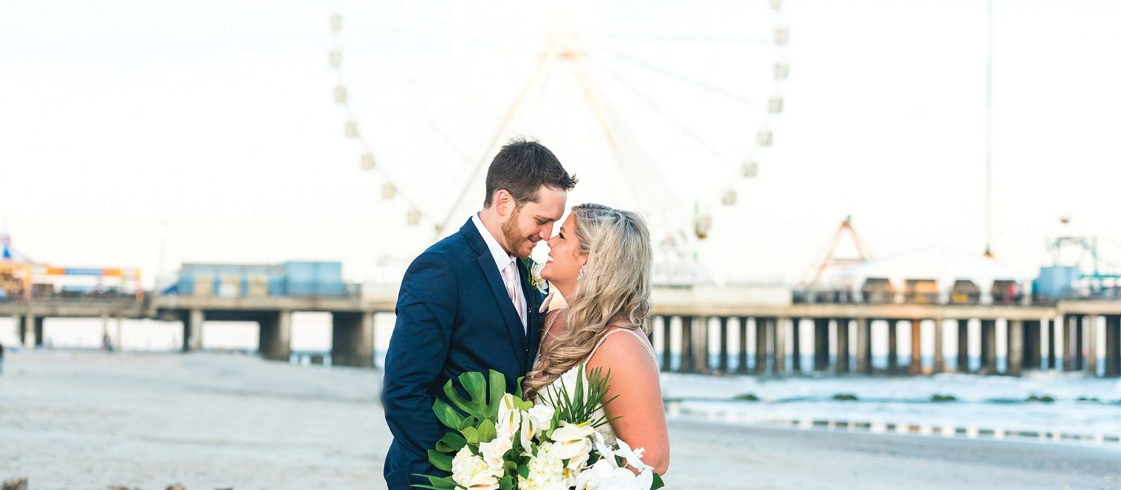 a newly wed couple on the beach